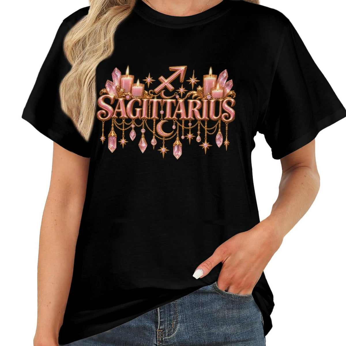 A woman wearing a black short-sleeve graphic T-shirt with a pink and gold 'SAGITTARIUS' zodiac design on the front, paired with blue jeans against a plain white background.